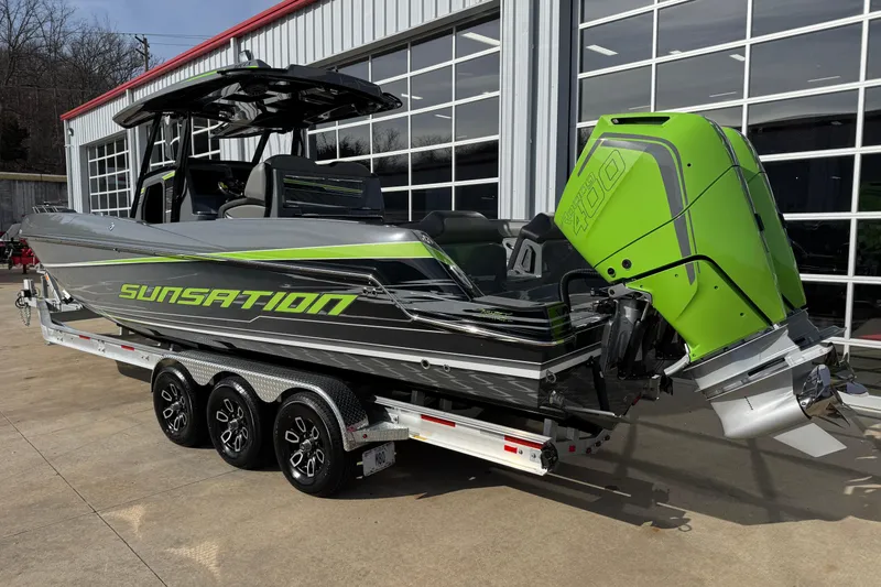 Slide: The Image of 2026 Sunsation 32 CCX boat with vibrant green accents on a trailer. - 5