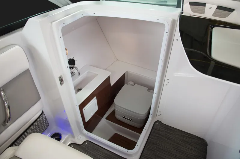 Slide: The Image of Manufacturer Provided Image: Interior of 2018 Four Winns HD240 OB boat with white seating and sleek console. - 18