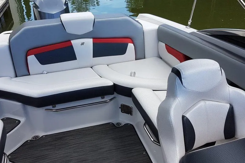 Slide: The Image of 2018 Four Winns HD240 OB boat with black canopy, docked on calm water. - 5