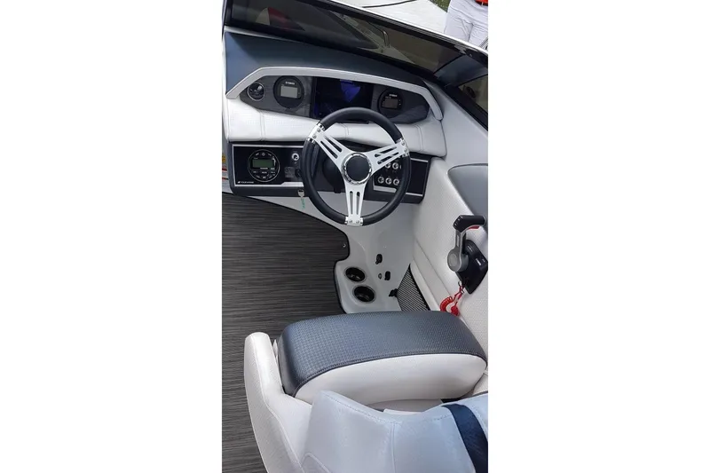 Slide: The Image of 2018 Four Winns HD240 OB boat on water, clear sky background. - 7