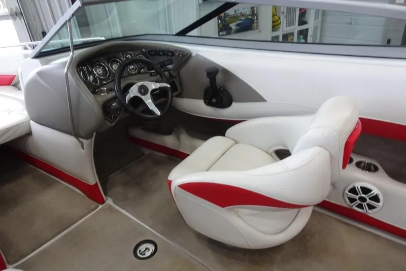 Slide: The Image of 2008 Crownline 23 SS boat interior with steering wheel and white-red seating. - 10