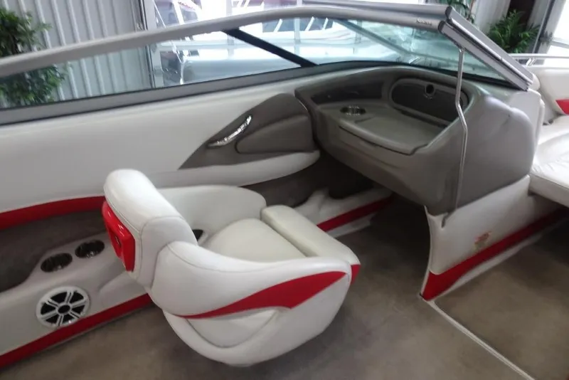Slide: The Image of 2008 Crownline 23 SS boat interior with white and red seating, dashboard, and cup holders. - 13
