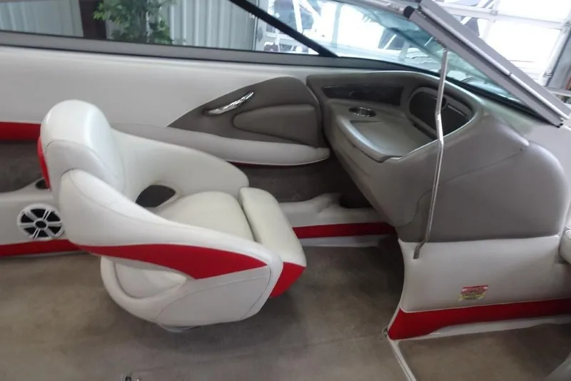 Slide: The Image of 2008 Crownline 23 SS boat interior with white and red seating, modern dashboard. - 14