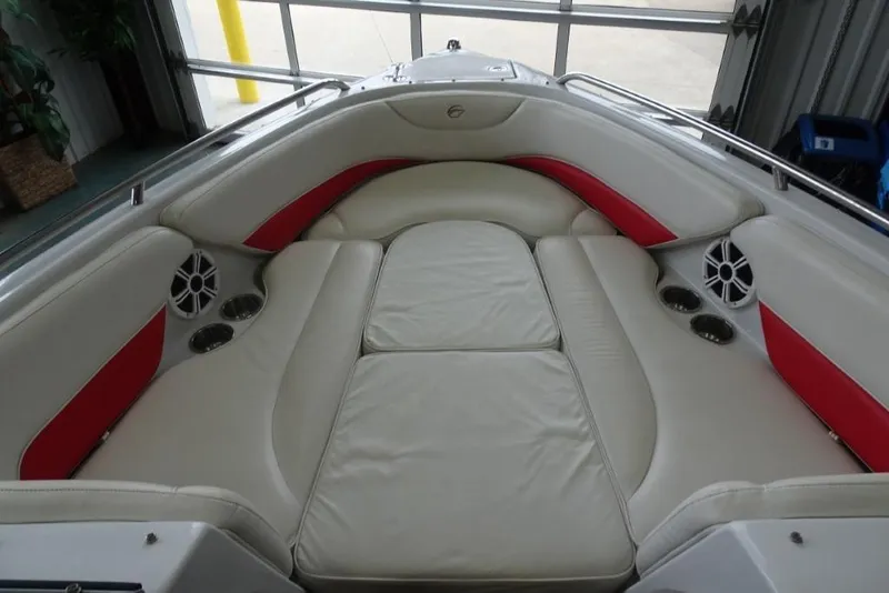 Slide: The Image of 2008 Crownline 23 SS boat interior with white and red seating, cup holders, and speakers. - 15
