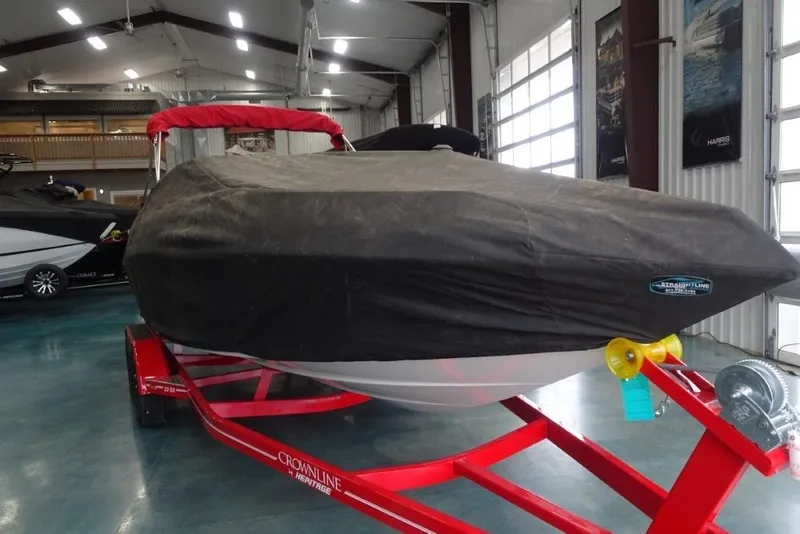 Slide: The Image of 2008 Crownline 23 SS boat covered on red trailer in indoor storage. - 18