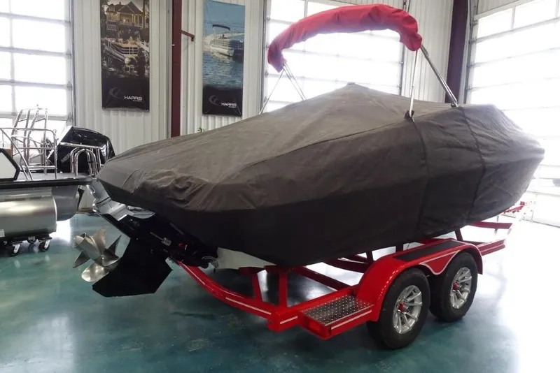 Slide: The Image of 2008 Crownline 23 SS boat covered on red trailer in indoor storage. - 20