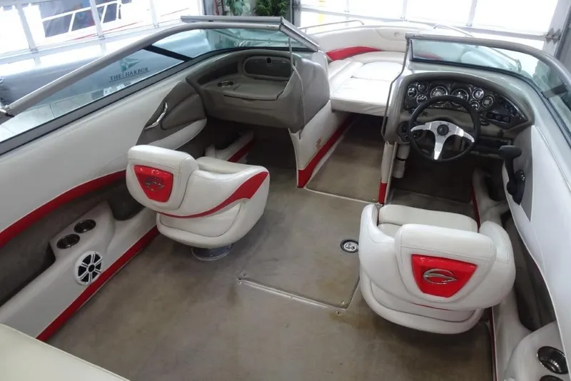 Slide: The Image of 2008 Crownline 23 SS boat interior with red and white seating, steering wheel, and dashboard. - 9