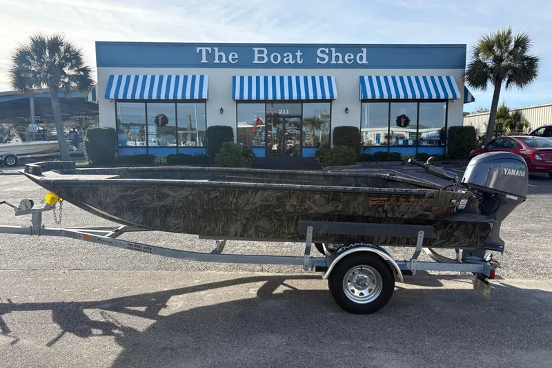 The Image of 2026 SeaArk 1752 Slayer X boat on trailer outside The Boat Shed dealership. - 1