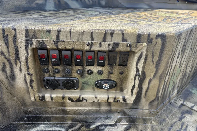 Slide: The Image of Control panel of 2026 SeaArk 1752 Slayer X boat with camouflage design. - 10