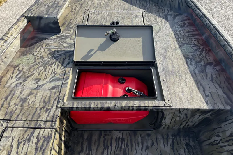 Slide: The Image of 2026 SeaArk 1752 Slayer X boat with open storage compartment and red fuel tank. - 12