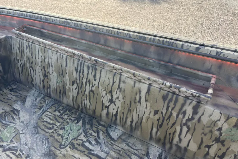 Slide: The Image of Camouflage interior of 2026 SeaArk 1752 Slayer X boat with storage compartment. - 13