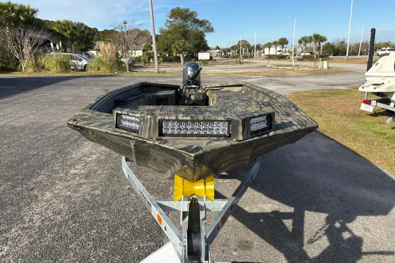 Slide: The Image of 2026 SeaArk 1752 Slayer X boat on trailer, featuring camouflage design and LED lights. - 7