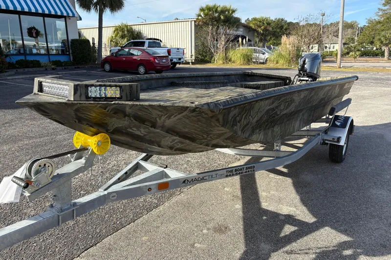 Slide: The Image of 2026 SeaArk 1752 Slayer X boat on trailer, parked outdoors in a lot. - 8