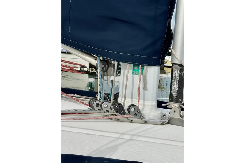 Slide: The Image of Close-up of rigging on a 2000 Sabre 402 sailboat, featuring ropes and pulleys. - 10