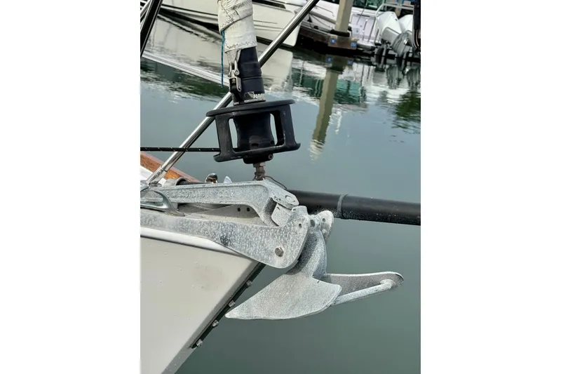 Slide: The Image of Bow of 2000 Sabre 402 sailboat with anchor and marina background. - 12