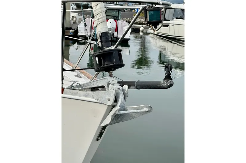 Slide: The Image of Bow of 2000 Sabre 402 sailboat with anchor and marina background. - 13