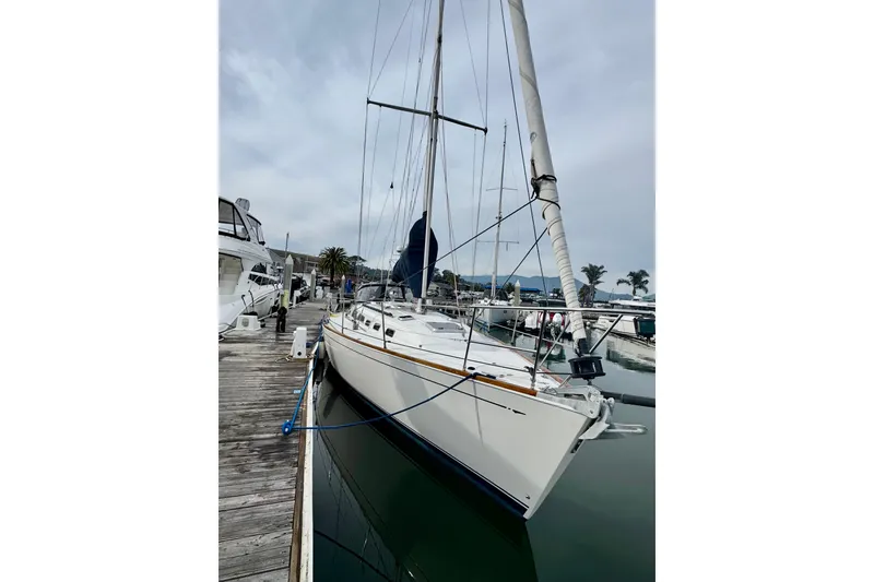 Slide: The Image of Sailboat Sabre 402, year 2000, docked at marina with clear sky background. - 14