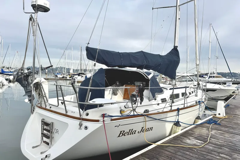 Slide: The Image of Sailboat "Bella Jean" docked, Sabre 402 model, year 2000, in a marina setting. - 2
