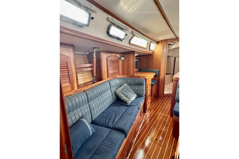 Slide: The Image of Interior of 2000 Sabre 402 yacht with wooden finish and blue cushioned seating. - 20
