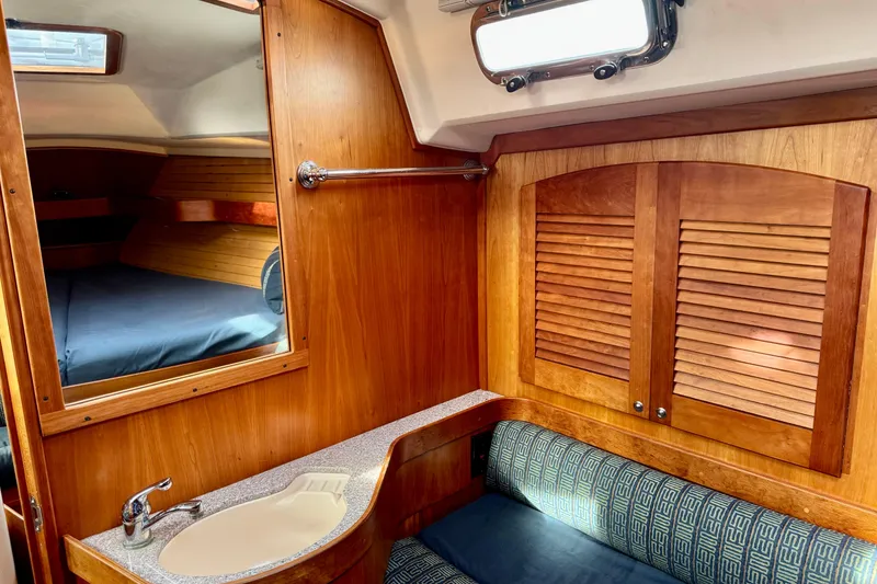 Slide: The Image of Interior of 2000 Sabre 402 sailboat with wood finish and cozy cabin space. - 24