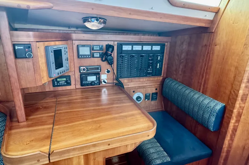 Slide: The Image of Navigation station in a 2000 Sabre 402 yacht with control panels and seating. - 29