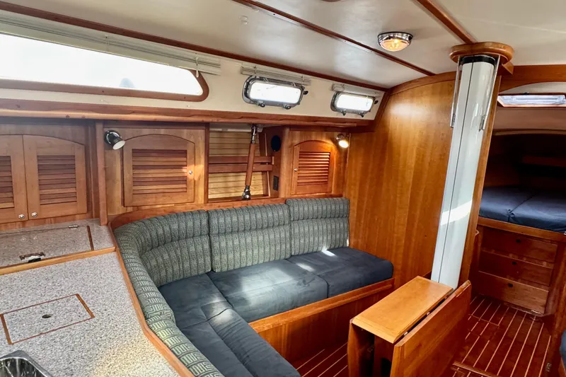 Slide: The Image of Interior of 2000 Sabre 402 yacht with wooden finish and cozy seating area. - 30