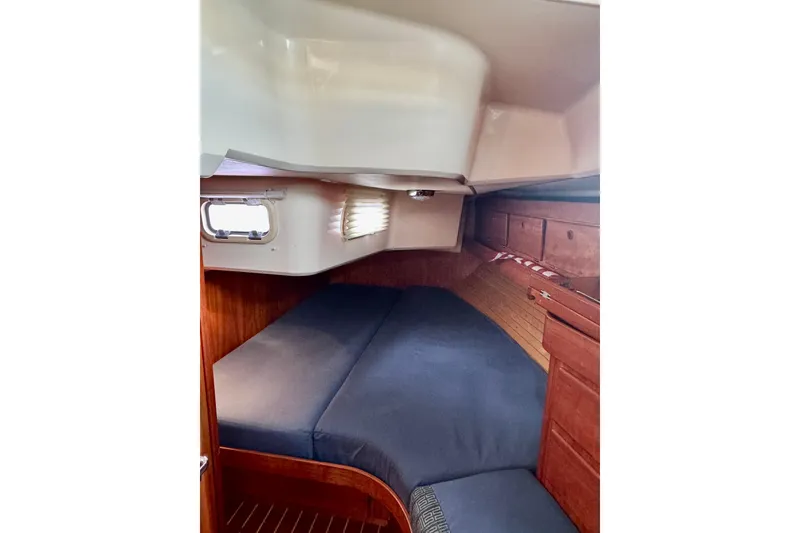 Slide: The Image of Cozy cabin interior of 2000 Sabre 402 sailboat with wooden finish and blue cushions. - 32