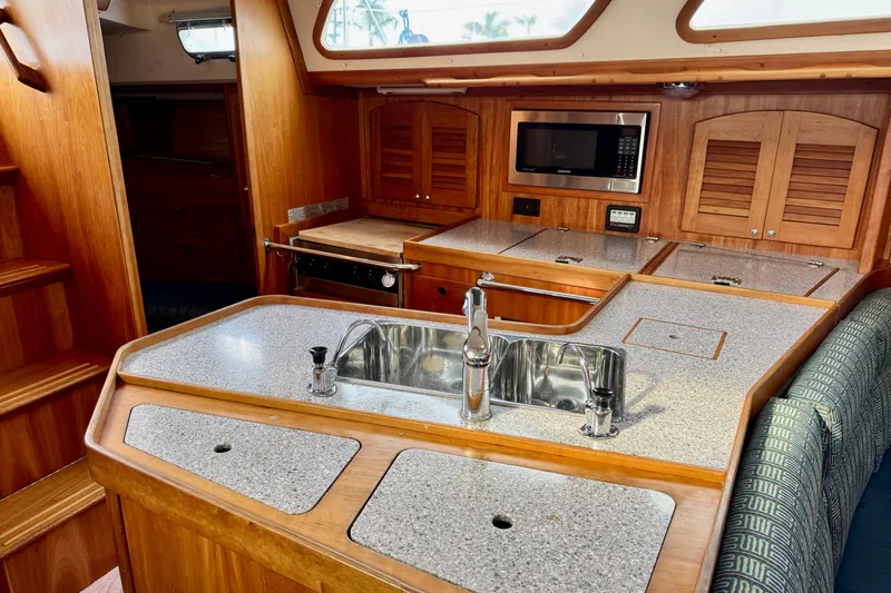 Slide: The Image of Luxurious Sabre 402 yacht kitchen interior with wood cabinetry and modern appliances, year 2000. - 38