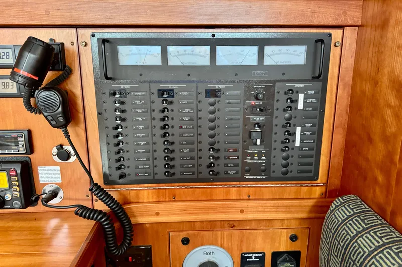 Slide: The Image of Electrical control panel on a 2000 Sabre 402 yacht, featuring various switches and meters. - 39