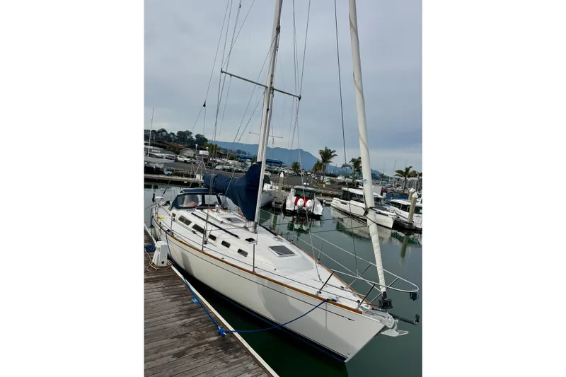 Slide: The Image of Sailboat Sabre 402, 2000 model, docked at marina with scenic mountain backdrop. - 5