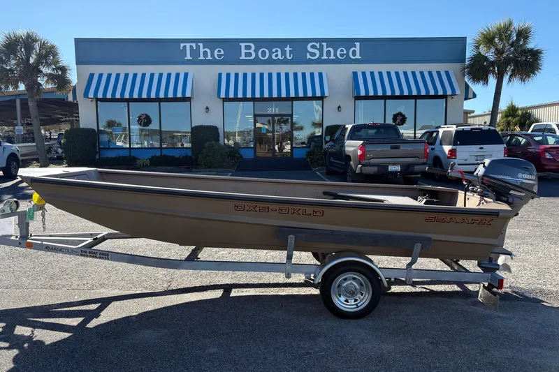 The Image of 2026 SeaArk DXS 1548 DKLD boat on trailer outside The Boat Shed dealership. - 1