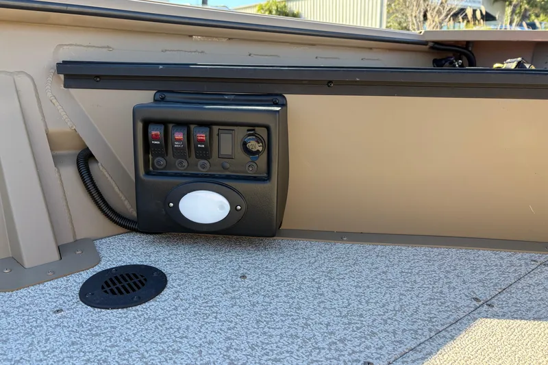 Slide: The Image of Control panel on 2026 SeaArk DXS 1548 DKLD boat interior. - 11