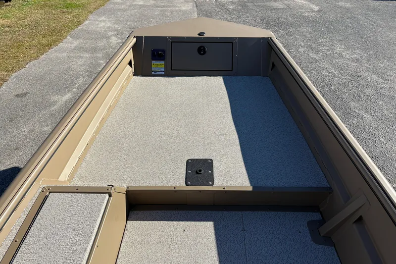 Slide: The Image of 2026 SeaArk DXS 1548 DKLD boat interior with textured flooring and storage compartment. - 13