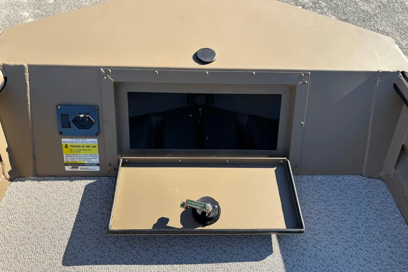 Slide: The Image of 2026 SeaArk DXS 1548 DKLD boat storage compartment with open lid and capacity label. - 14