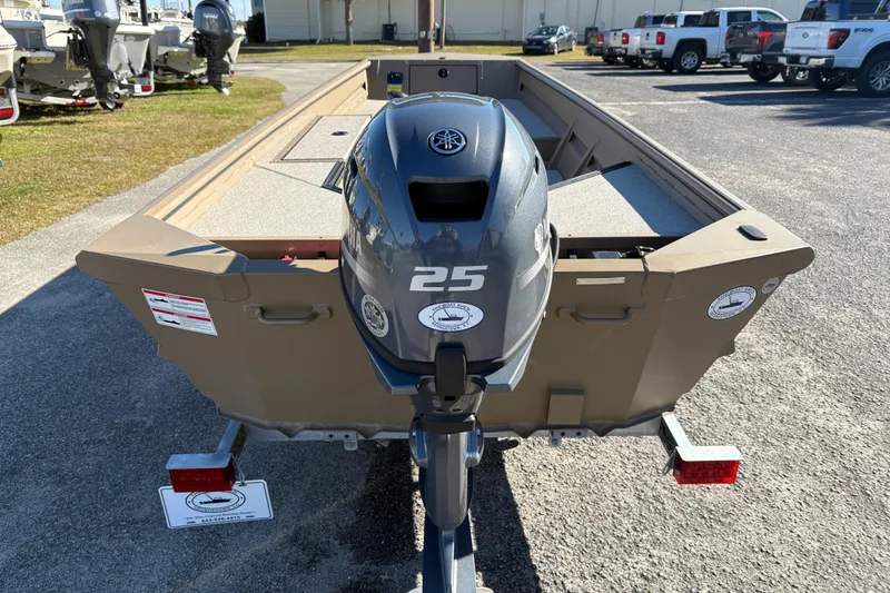 Slide: The Image of 2026 SeaArk DXS 1548 DKLD boat with Yamaha 25 outboard motor, parked outdoors. - 3