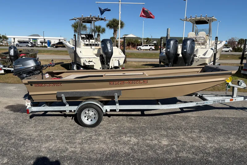 Slide: The Image of 2026 SeaArk DXS 1548 DKLD boat on trailer, parked outdoors. - 5