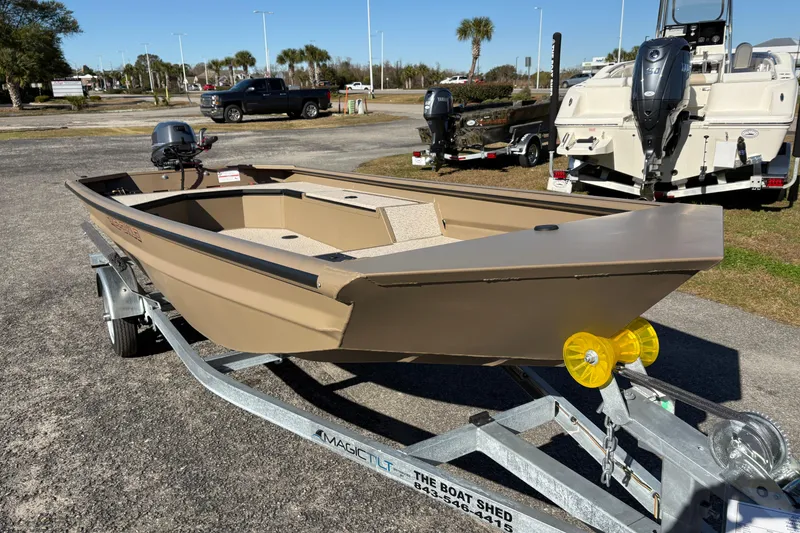 Slide: The Image of 2026 SeaArk DXS 1548 DKLD boat on trailer, parked outdoors. - 6