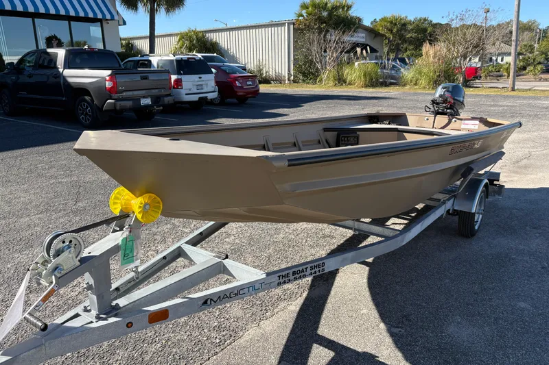 Slide: The Image of 2026 SeaArk DXS 1548 DKLD boat on trailer in parking lot. - 8