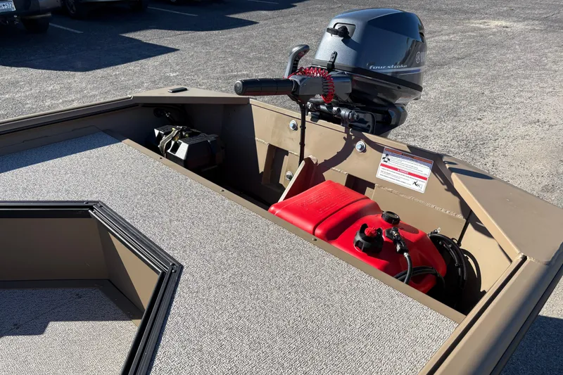 Slide: The Image of 2026 SeaArk DXS 1548 DKLD boat with outboard motor and red fuel tank. - 9