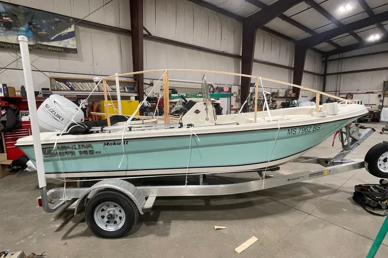 The Image of 2021 Carolina Skiff 162 JLS boat on trailer in indoor garage setting. - 0