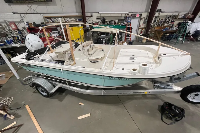 Slide: The Image of 2021 Carolina Skiff 162 JLS boat on trailer in workshop setting. - 1