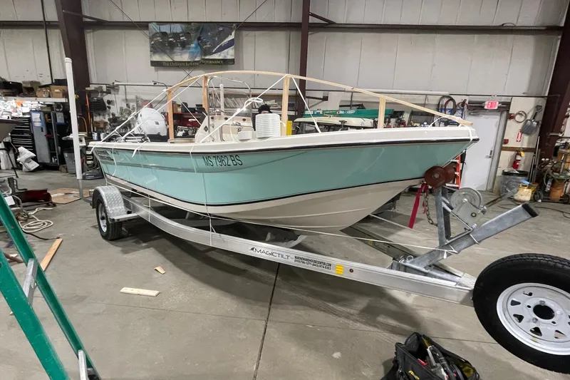 Slide: The Image of 2021 Carolina Skiff 162 JLS boat on trailer in a workshop setting. - 2