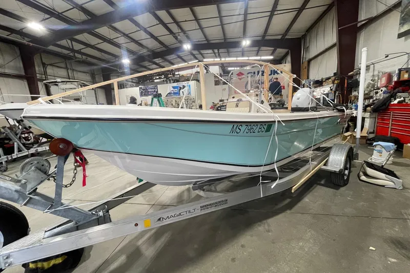 Slide: The Image of 2021 Carolina Skiff 162 JLS boat on trailer in a workshop setting. - 3