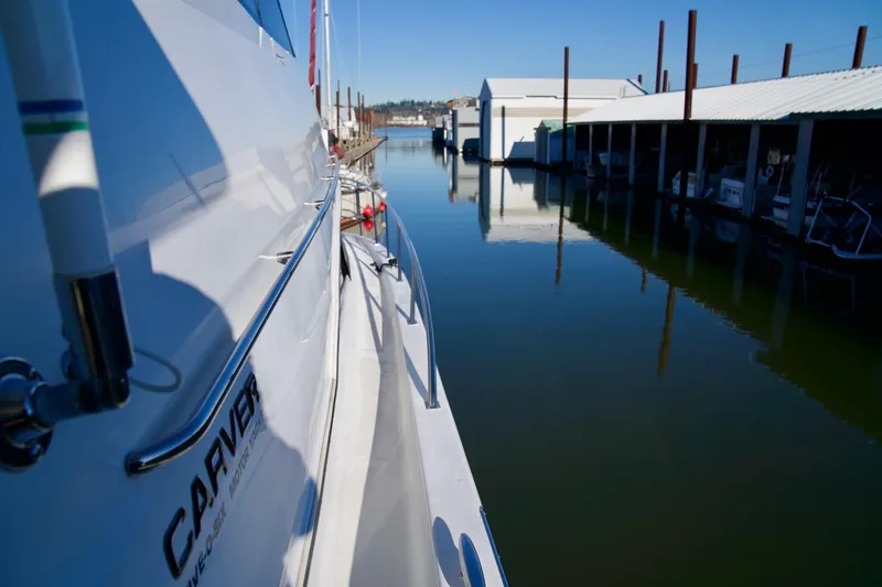 Slide: The Image of Carver 506 Motor Yacht, 2000 model, docked in a serene marina setting. - 10