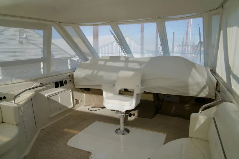 Slide: The Image of Interior of 2000 Carver 506 Motor Yacht with helm chair and covered controls. - 20