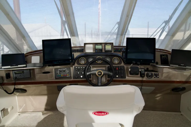 Slide: The Image of Helm of 2000 Carver 506 Motor Yacht with multiple navigation screens and controls. - 22