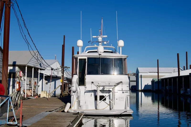 Slide: The Image of 2000 Carver 506 Motor Yacht docked at marina under clear blue sky. - 3