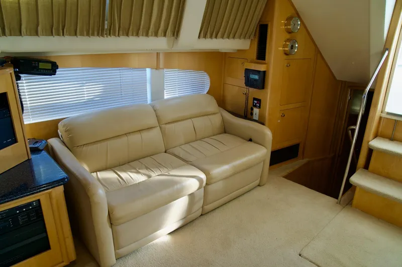 Slide: The Image of Interior of 2000 Carver 506 Motor Yacht with beige sofa and wooden accents. - 36