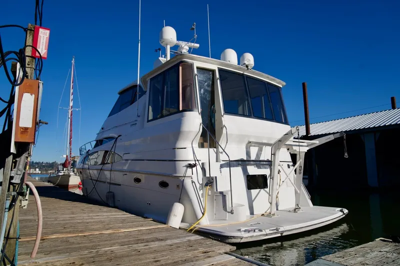 Slide: The Image of Carver 506 Motor Yacht 2000 docked at marina under clear blue sky. - 4