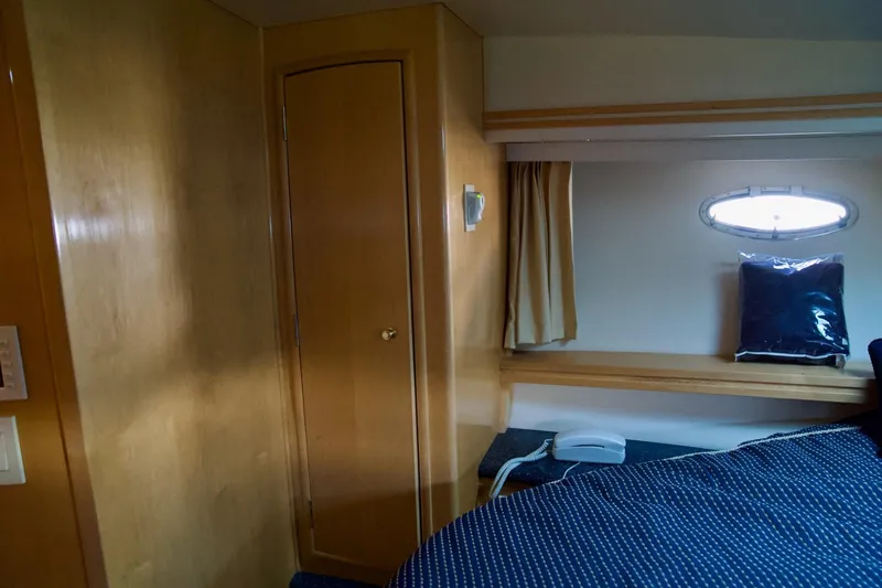Slide: The Image of Interior cabin of 2000 Carver 506 Motor Yacht with wooden paneling and porthole window. - 45
